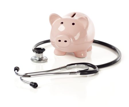 Piggy,Bank,And,Stethoscope,Isolated,On,A,White,Background,With